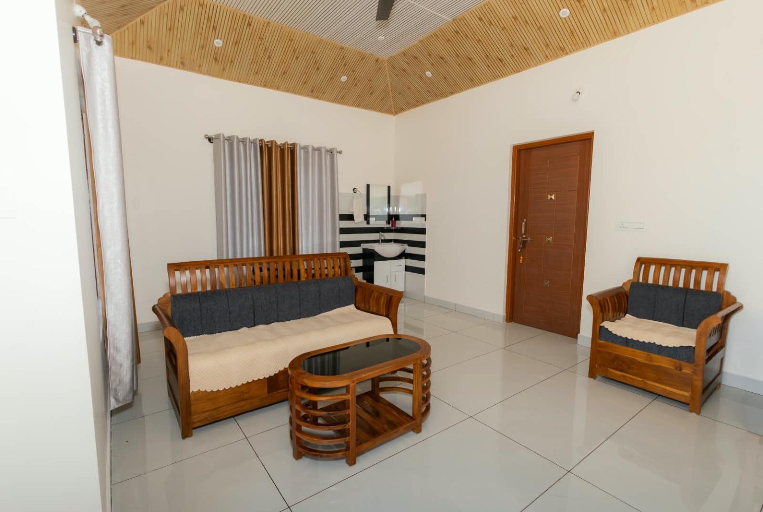 Living area with wooden furniture at Saathvi’s Nest